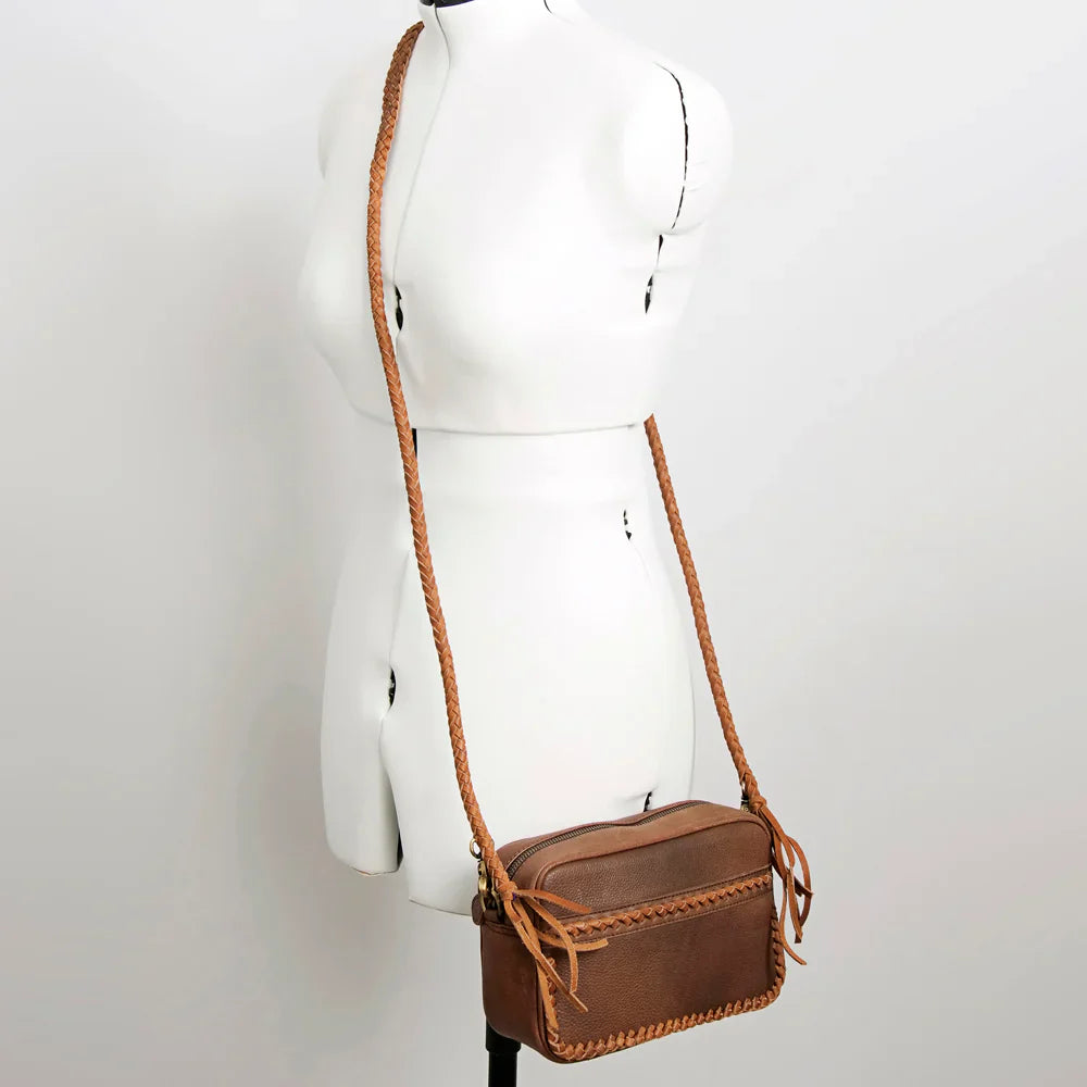 American Darling small crossbody messenger bag in genuine full grain leather with braided detailing and adjustable strap.