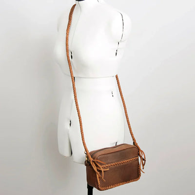 American Darling small crossbody messenger bag in genuine full grain leather with braided detailing and adjustable strap.