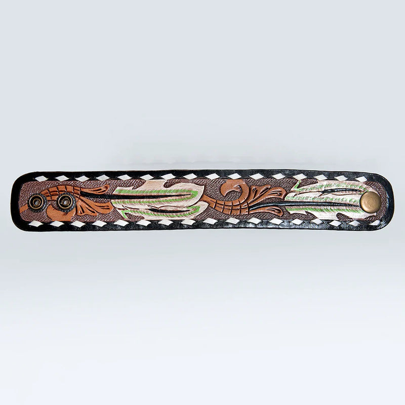 Hand-tooled American Darling Bracelet with carved feather design, black edge, white whipstitch, and dual-snap closure.