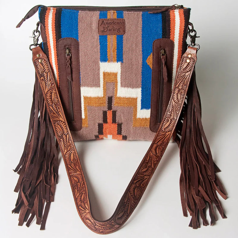 American Darling Large Crossbody Messenger Bag ADBGZ568 made of hand-tooled vegetable tanned leather with woven wool saddle blanket and leather fringes