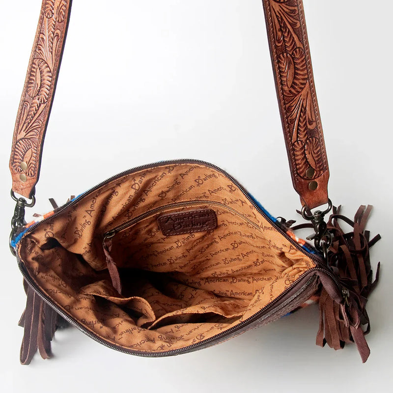 American Darling Large Crossbody Messenger Bag ADBGZ568 with hand-tooled vegetable tanned cowhide leather, leather fringes, adjustable shoulder strap, wool saddle blanket detail, antique metal fittings, and branded zipper closure, open interior view