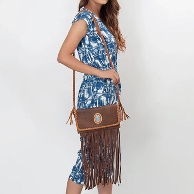 American Darling Small Crossbody Messenger Bag with fringes, turquoise stone, and adjustable leather strap.