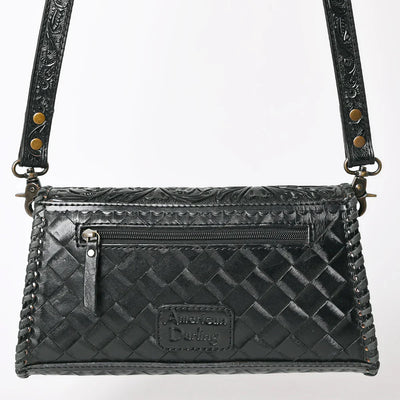 Black American Darling crossbody bag with hand-tooled vegetable tanned cowhide leather, detailed braiding, adjustable strap, and YKK zipper.