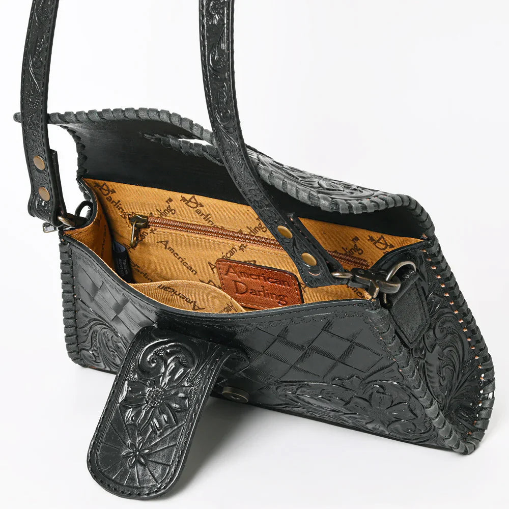 Black American Darling crossbody bag with detailed hand-tooled leather and adjustable strap, featuring braided accents and YKK zipper closure.