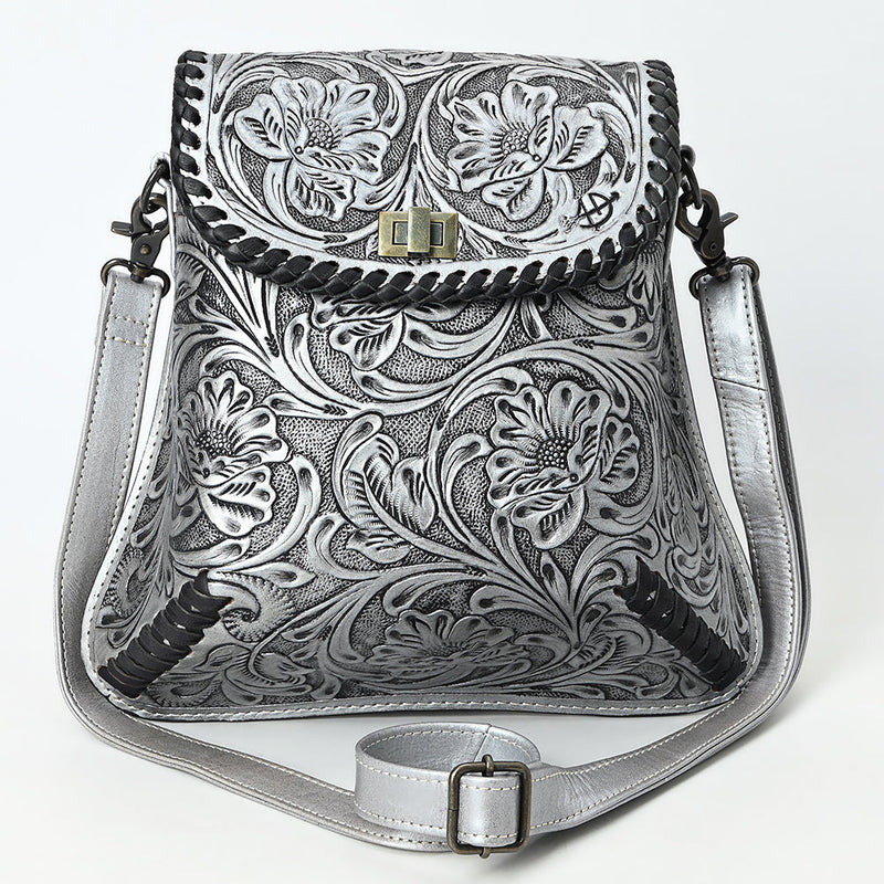 American Darling small crossbody bag in hand-tooled, carved vegetable tanned cowhide leather with adjustable strap and antique metal fittings