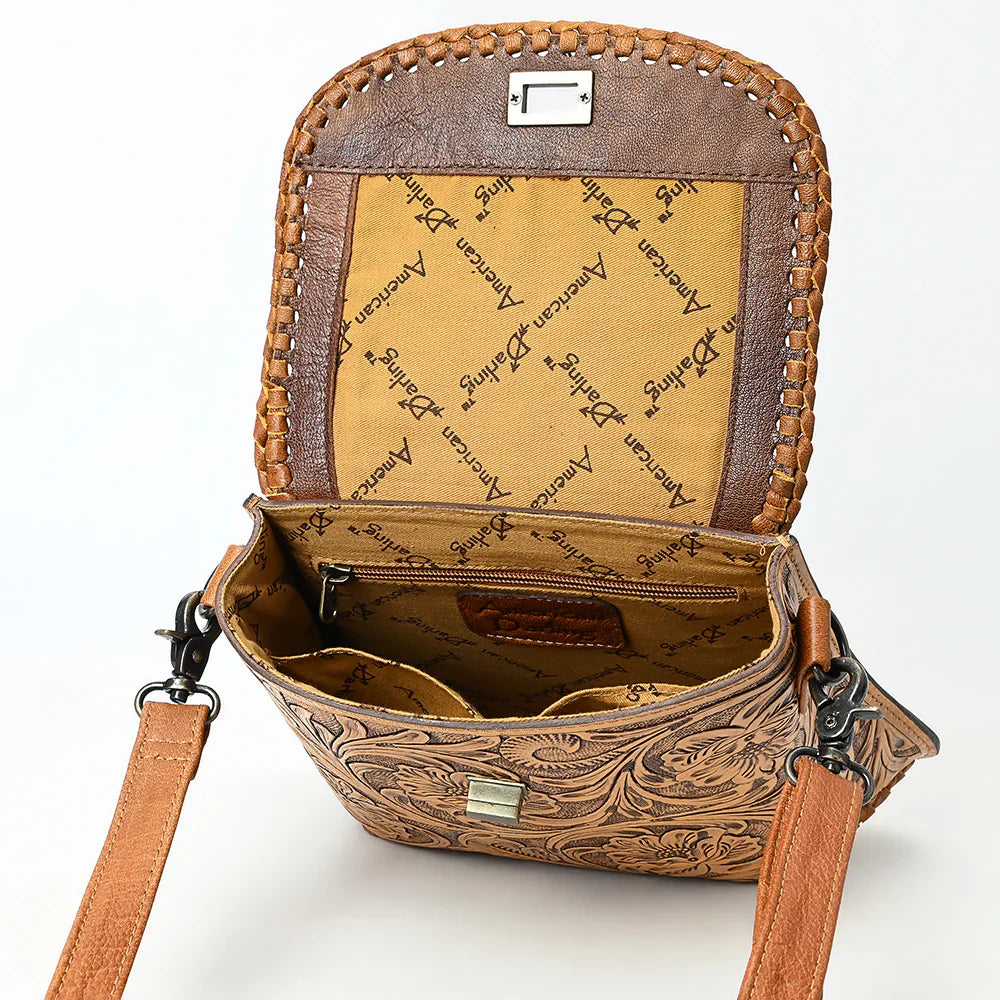 American Darling Small Crossbody Bag in hand-tooled full grain leather with adjustable strap and antique metal fittings, open to show interior compartments and branded lining