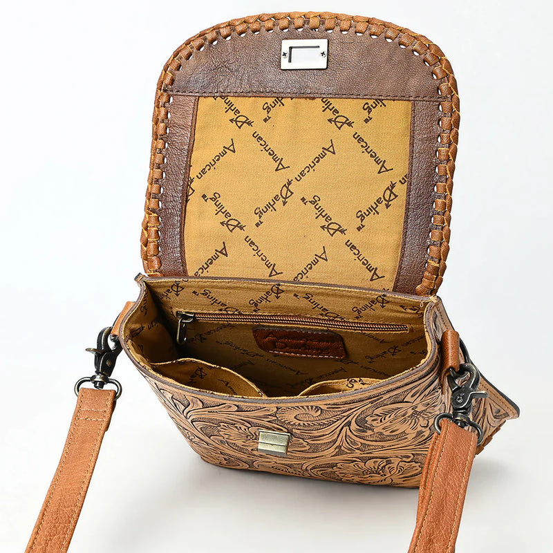 American Darling Small Crossbody Bag in hand-tooled full grain leather with adjustable strap and antique metal fittings, open to show interior compartments and branded lining