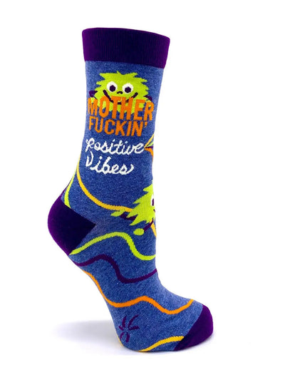 Colorful women's crew socks with "Mother F***in' Positive Vibes" text and playful monster design, size 5-10