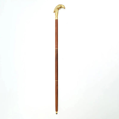 Decorative vintage walking stick with carved brass eagle head handle and polished wooden shaft.