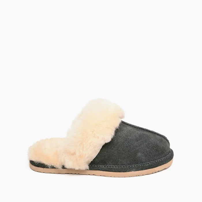 Minnetonka sheepskin slide shoes with open-back design and premium suede upper.