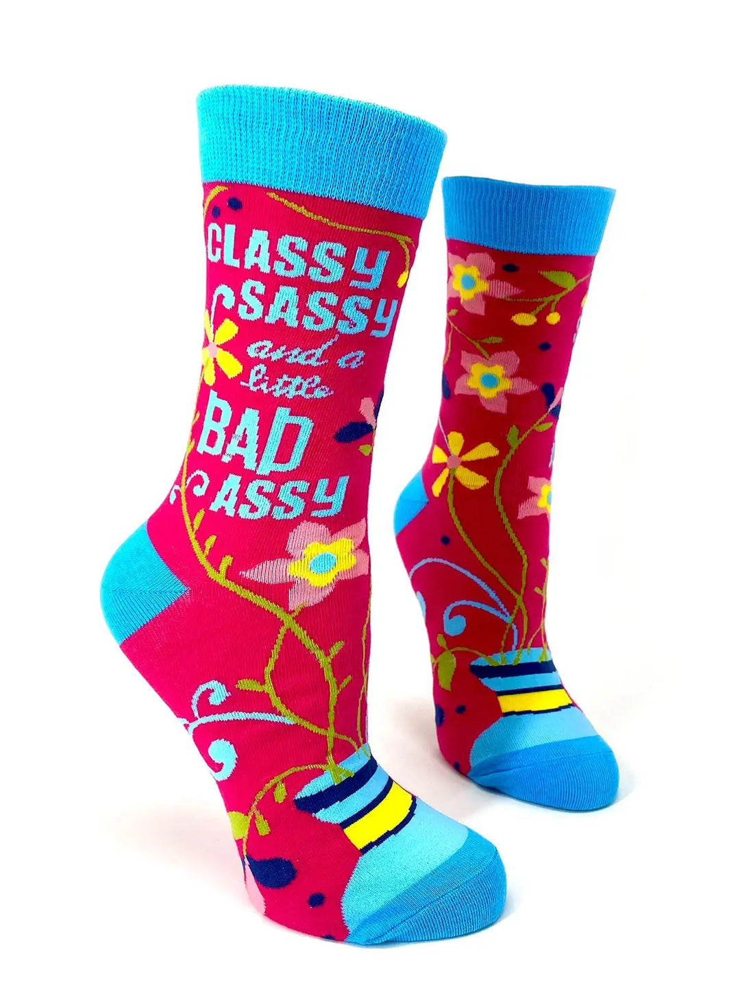 Brightly colored women's crew socks with blue cuffs, heels, and toes, featuring the phrase "Classy Sassy and a Little Bad Assy" in bold white letters and decorated with multicolored floral patterns.