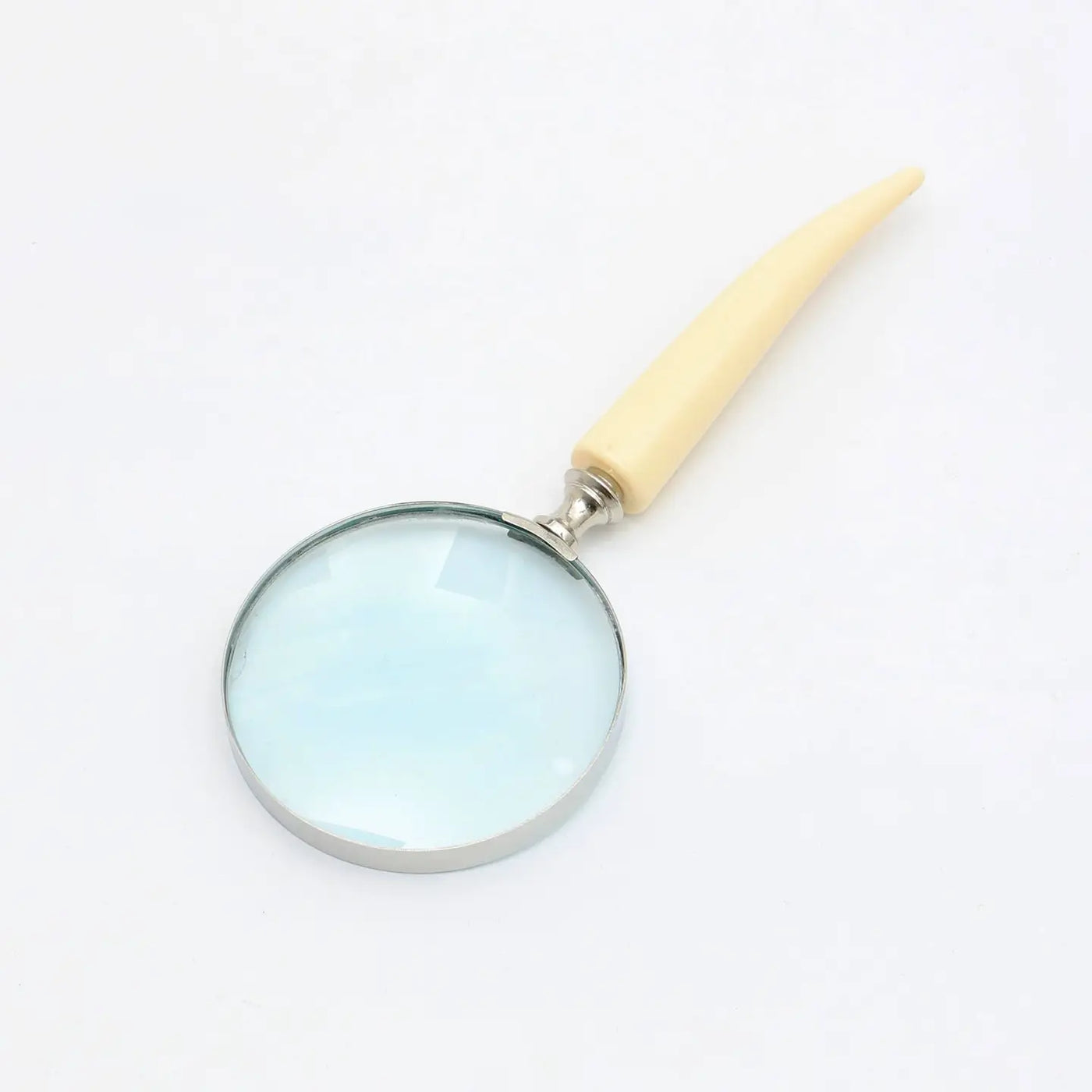 Decorative magnifying glass with ivory resin handle and silver electroplated finish, elegant and functional for reading and decor.