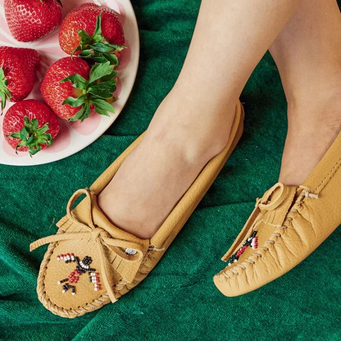 Minnetonka Thunderbird Softsole moccasins in tan suede with iconic Thunderbird beading and cotton lace detailing.