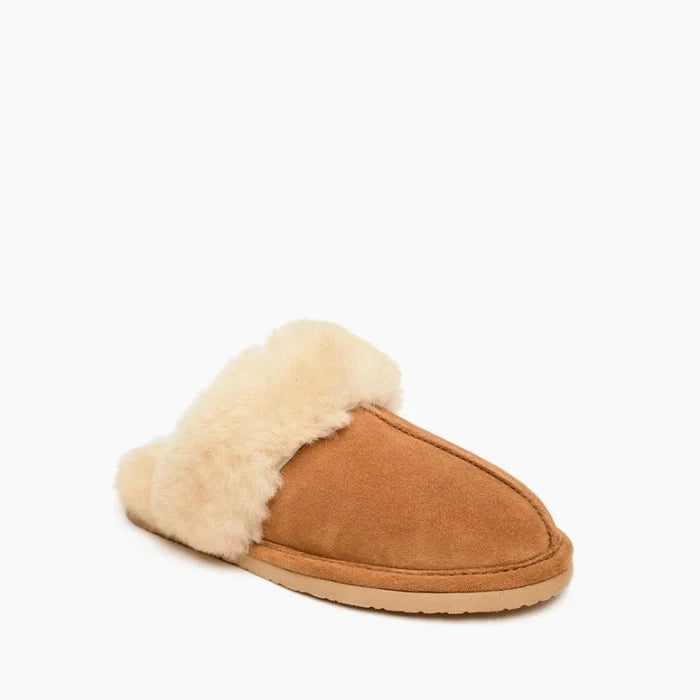 Minnetonka sheepskin slide shoes with open-back design and suede upper.