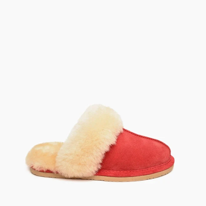 Red Minnetonka sheepskin slide shoes with soft lining and open-back design.