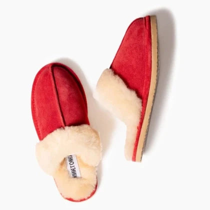 Minnetonka sheepskin slide shoes with open-back design and premium suede upper.