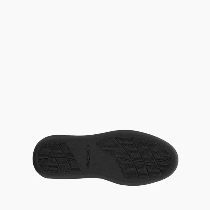 Rubber sole of the Pre Order Minnetonka Sheepskin Ankle Boot providing superior grip and stability.