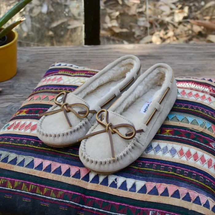 Luxurious suede Minnetonka CALLY shoes with sheepskin lining, perfect for cold weather comfort.