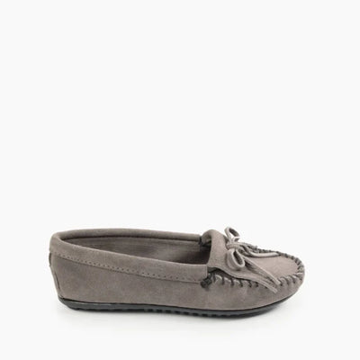 Minnetonka Kilty Hardsole moccasin in gray suede with intricate stitching and durable rubber sole.