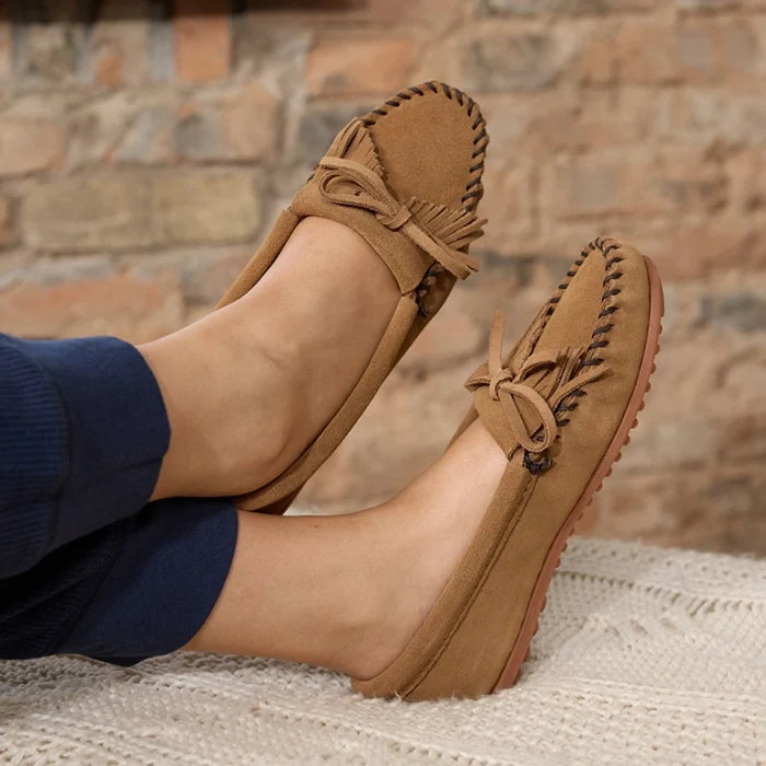 Minnetonka Kilty Hardsole moccasins in premium suede leather with intricate stitching and rubber sole.