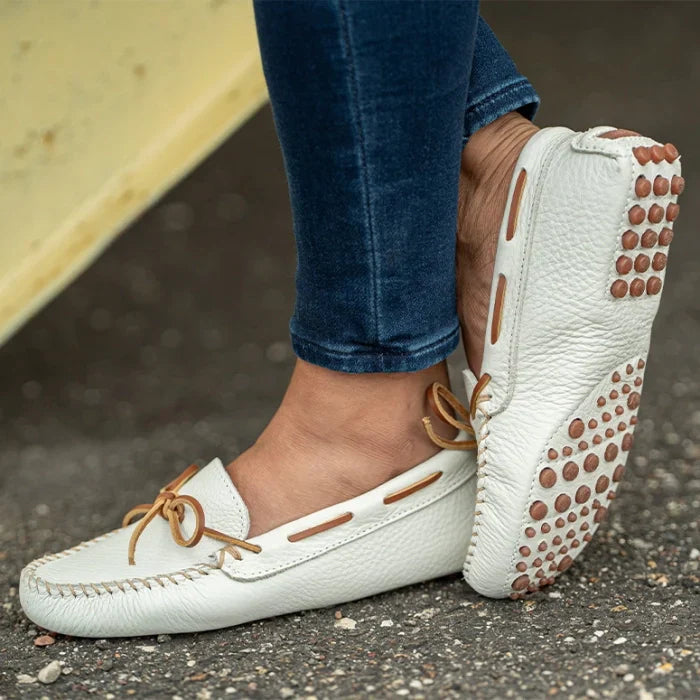 Minnetonka Classic Driver moccasins for women with handcrafted leather and rawhide lace detail.