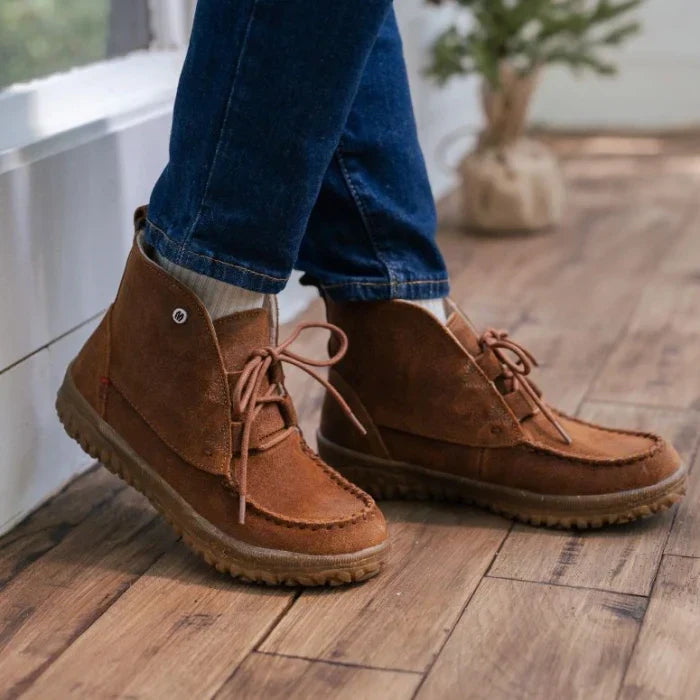 Minnetonka Tealey Shoes in brown suede with sturdy tread worn with jeans on wooden floor