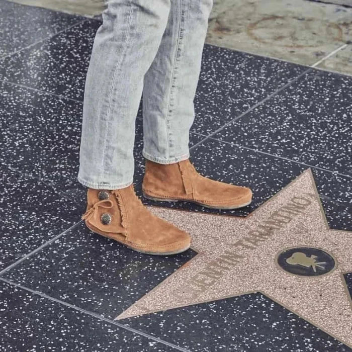 Minnetonka men's Two Button Boot in soft brown suede with metal conchos and padded insole, hardsole and softsole options.