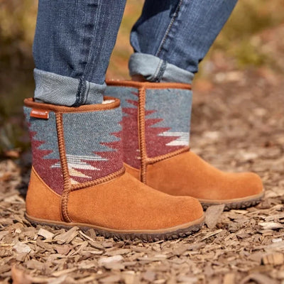 Minnetonka TALI shoes in premium suede with vibrant multi-pattern fabric worn outdoors.