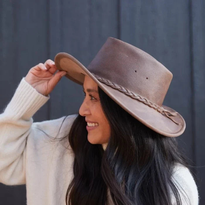 Pre-order Minnetonka Fold Up Hat made of premium leather with braided band, worn outdoors.