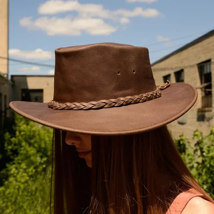 Minnetonka Fold Up Hat in brown leather with braided hatband and wide brim, ideal for outdoor adventures.