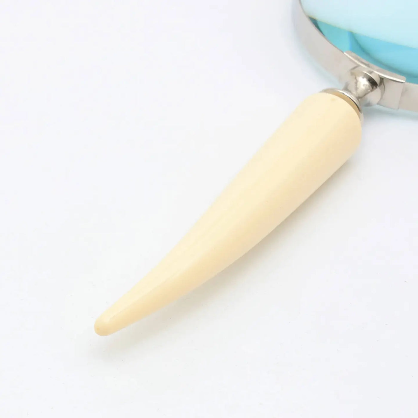 Decorative magnifying glass featuring an ivory resin handle with a silver electroplated finish.