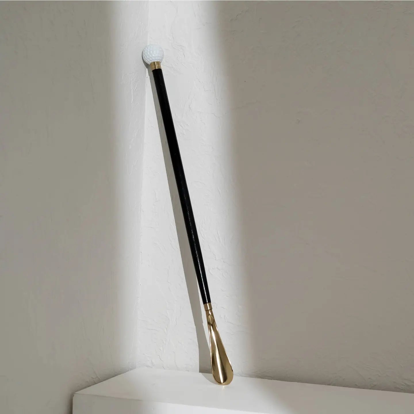 29-inch black wooden shoehorn with metal handle and sleek spray-painted finish for easy shoe wearing without bending