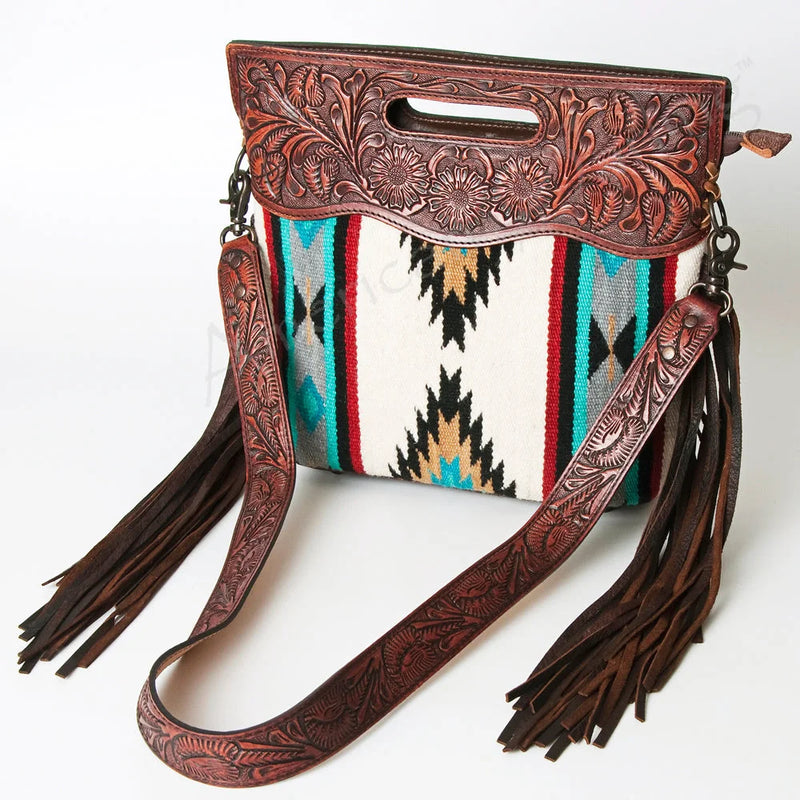 American Darling Clutch ADBG247 with hand-woven wool saddle blanket, full grain leather, leather fringes, embossed floral design, and adjustable leather strap.