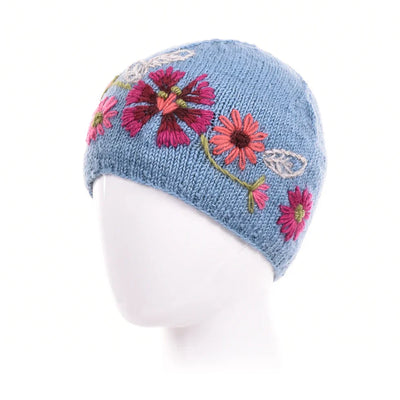 Light blue Stella Wool Beanie with hand-embroidered pink and red floral designs on soft knitted wool.