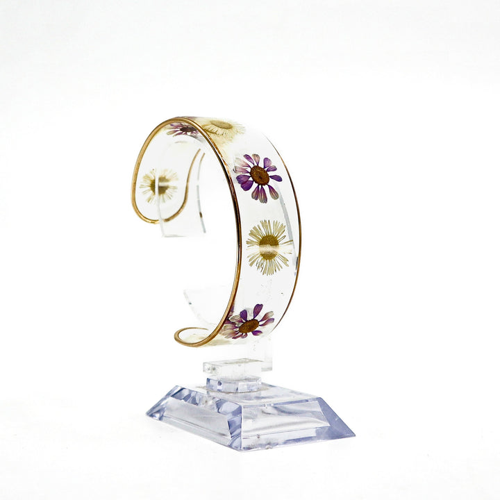 Dried flower resin cuff bracelet with preserved floral design on clear band
