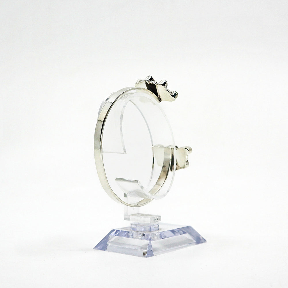 Handmade sterling silver cuff bracelet with turquoise stones on display stand