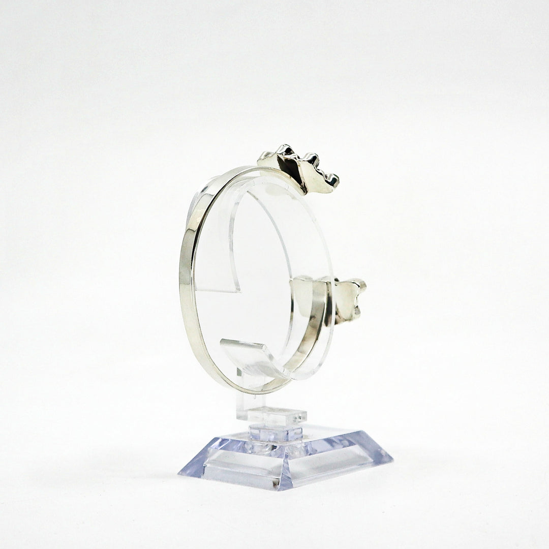 Handmade sterling silver cuff bracelet with turquoise stones on display stand