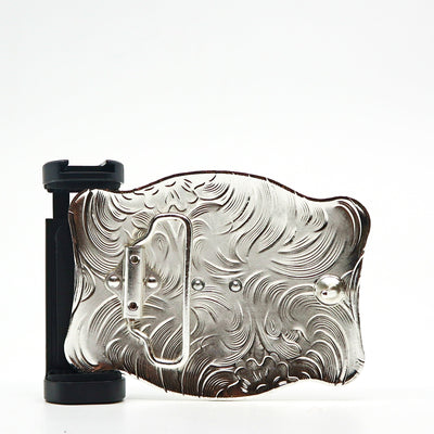Ornate silver belt buckle PSTPBB00 with intricate swirling patterns and black attachment mechanism