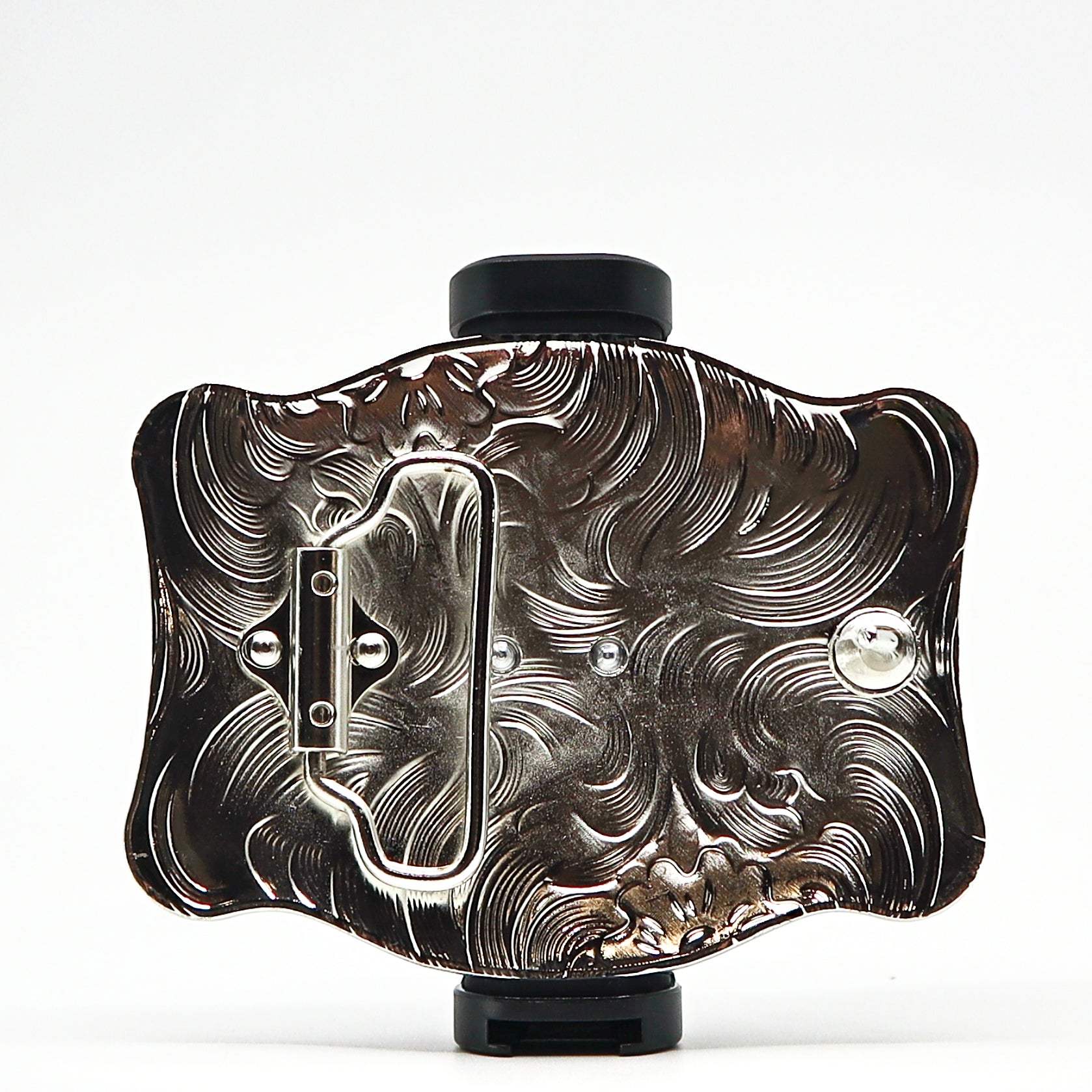 Intricately designed metal belt buckle with engraved floral patterns and a polished finish