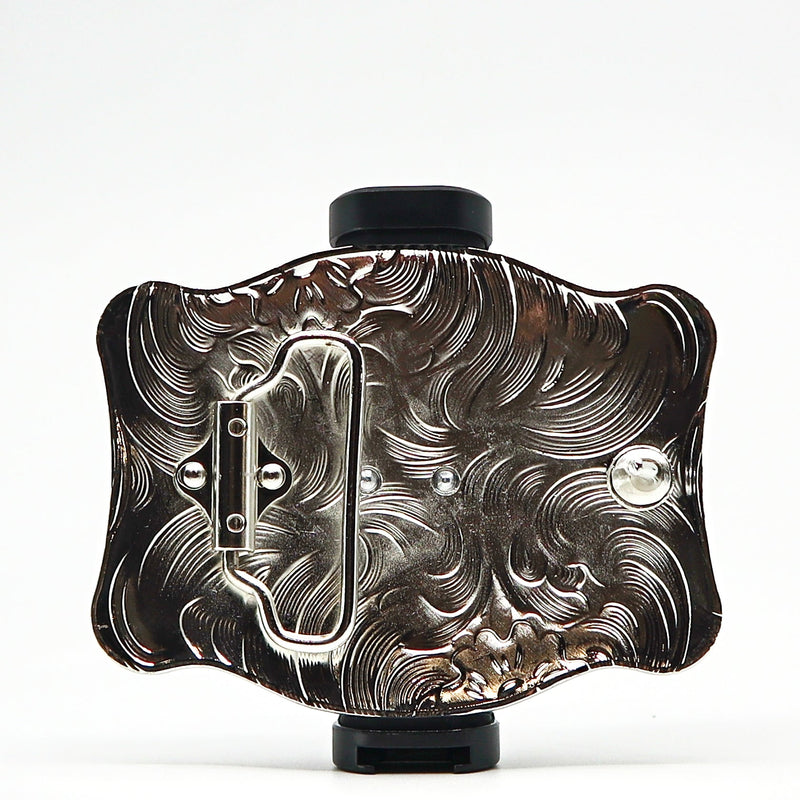 Intricately designed metal belt buckle with engraved floral patterns and a polished finish