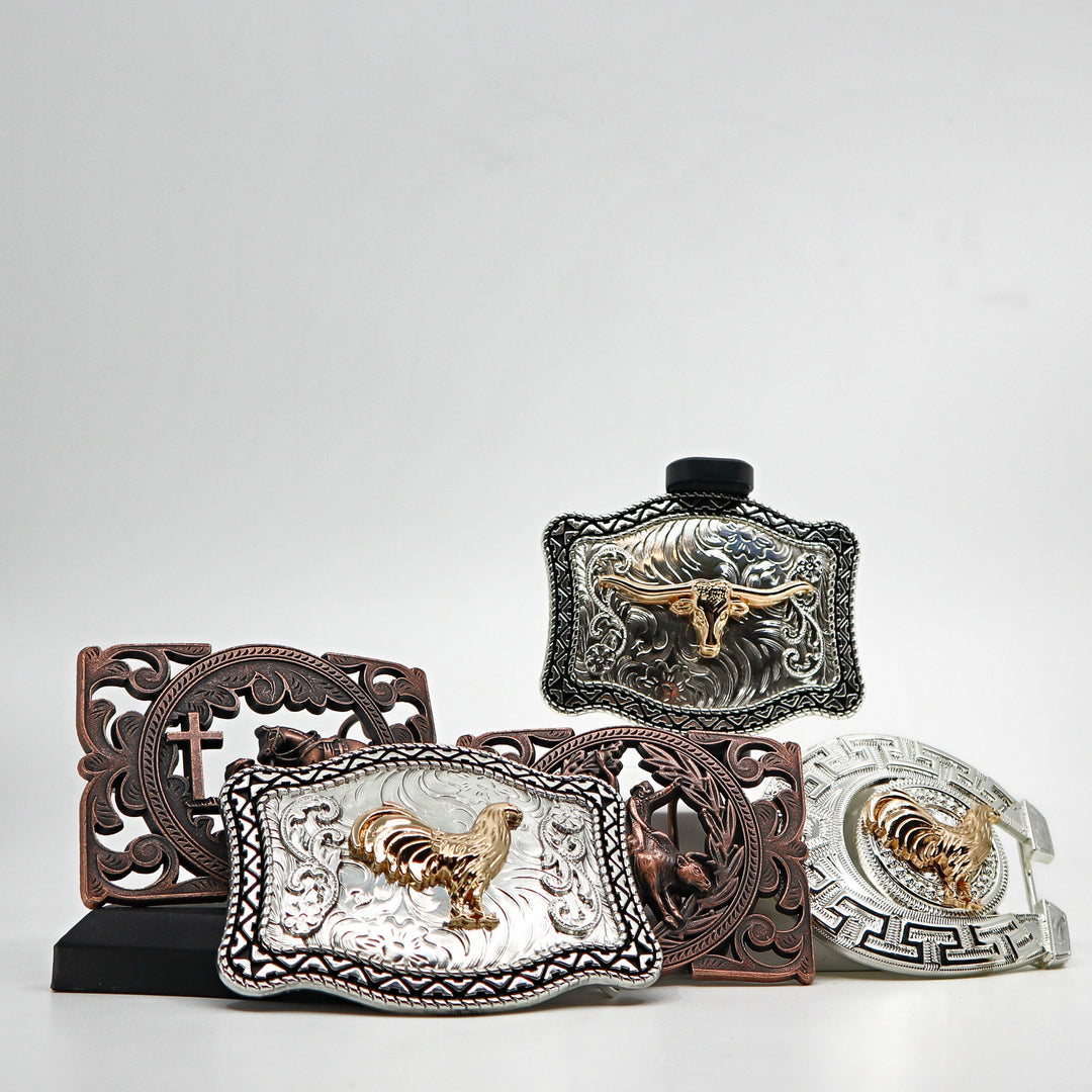 Collection of decorative metal belt buckles with intricate designs and animal motifs including a rooster and a longhorn skull.