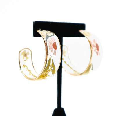 Dried flower hoop earrings with delicate petals on gold hoops