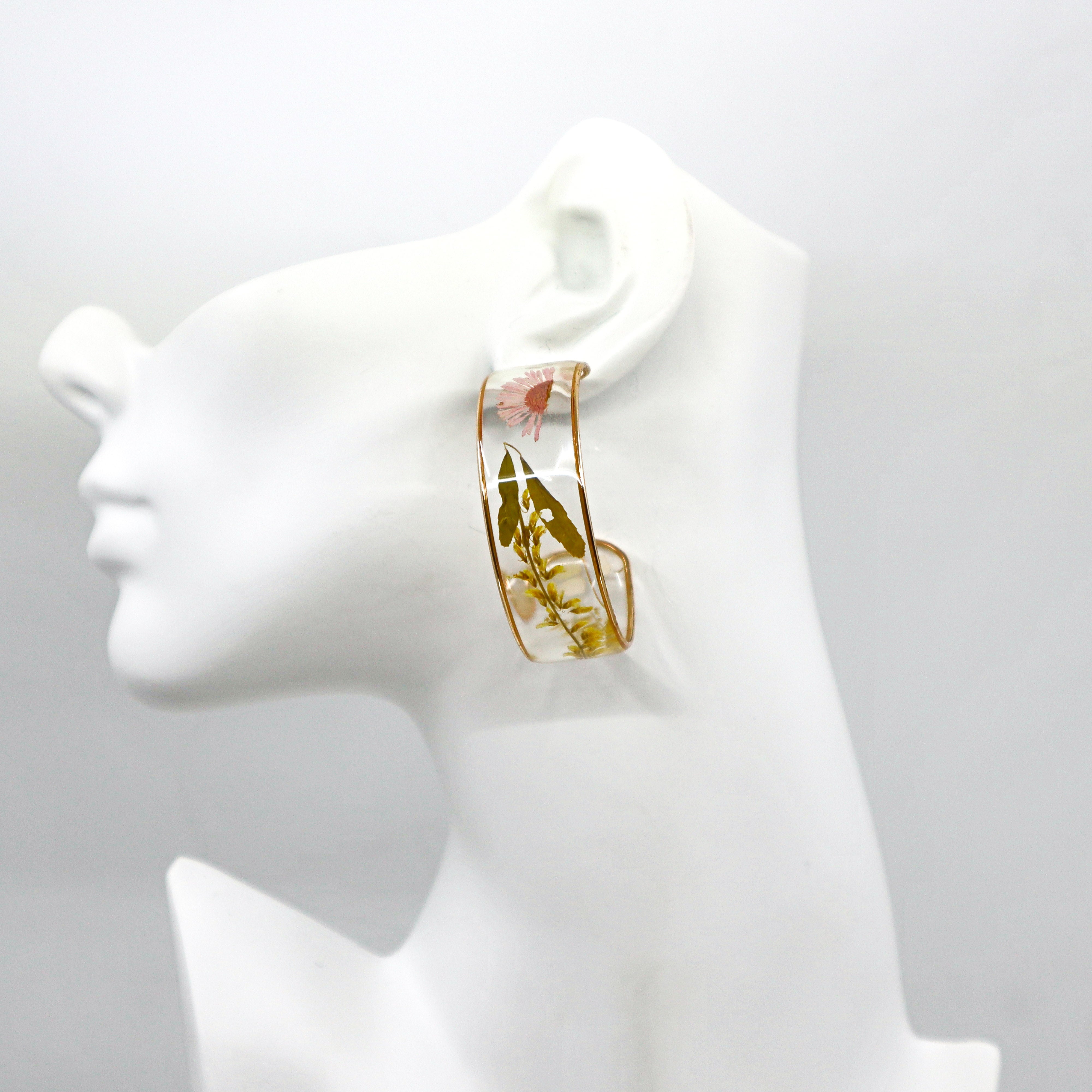 Dried flower hoop earrings with delicate petals in a circular design