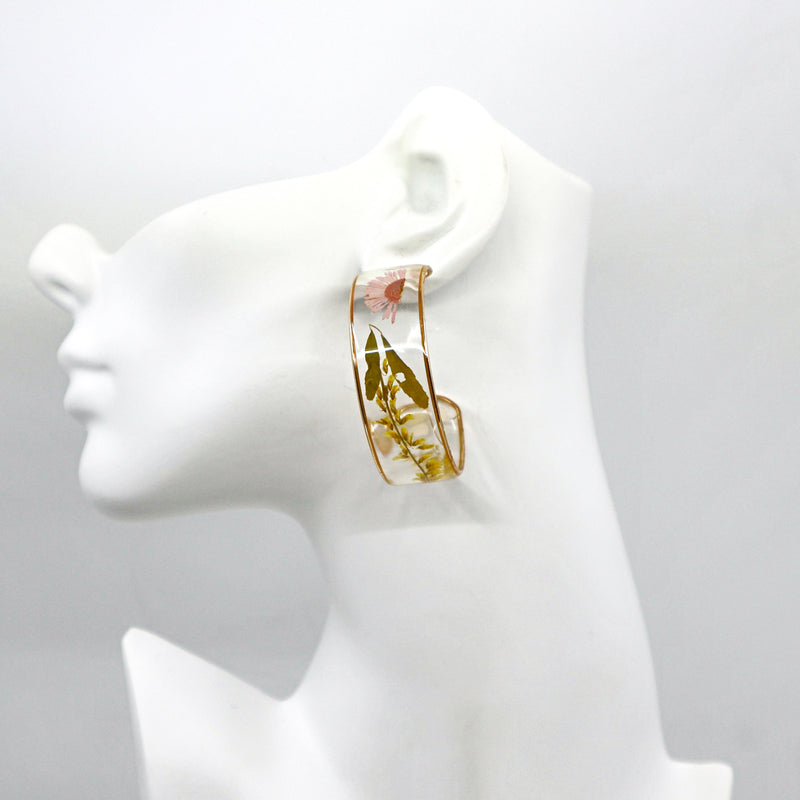 Dried flower hoop earrings with delicate petals in a circular design
