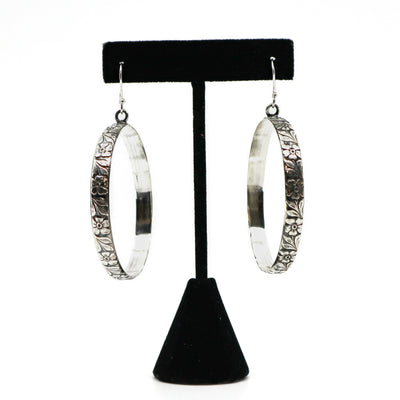 Handmade sterling silver floral hoop earrings on black stand