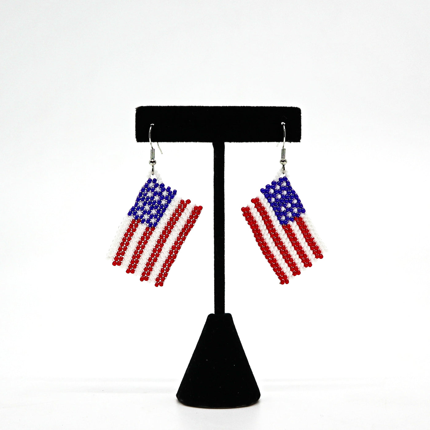 Boho USA flag beaded tassel earrings with handwoven rice beads in red, white, and blue colors, lightweight and patriotic design.