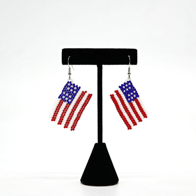 Boho USA flag beaded tassel earrings with handwoven rice beads in red, white, and blue colors, lightweight and patriotic design.