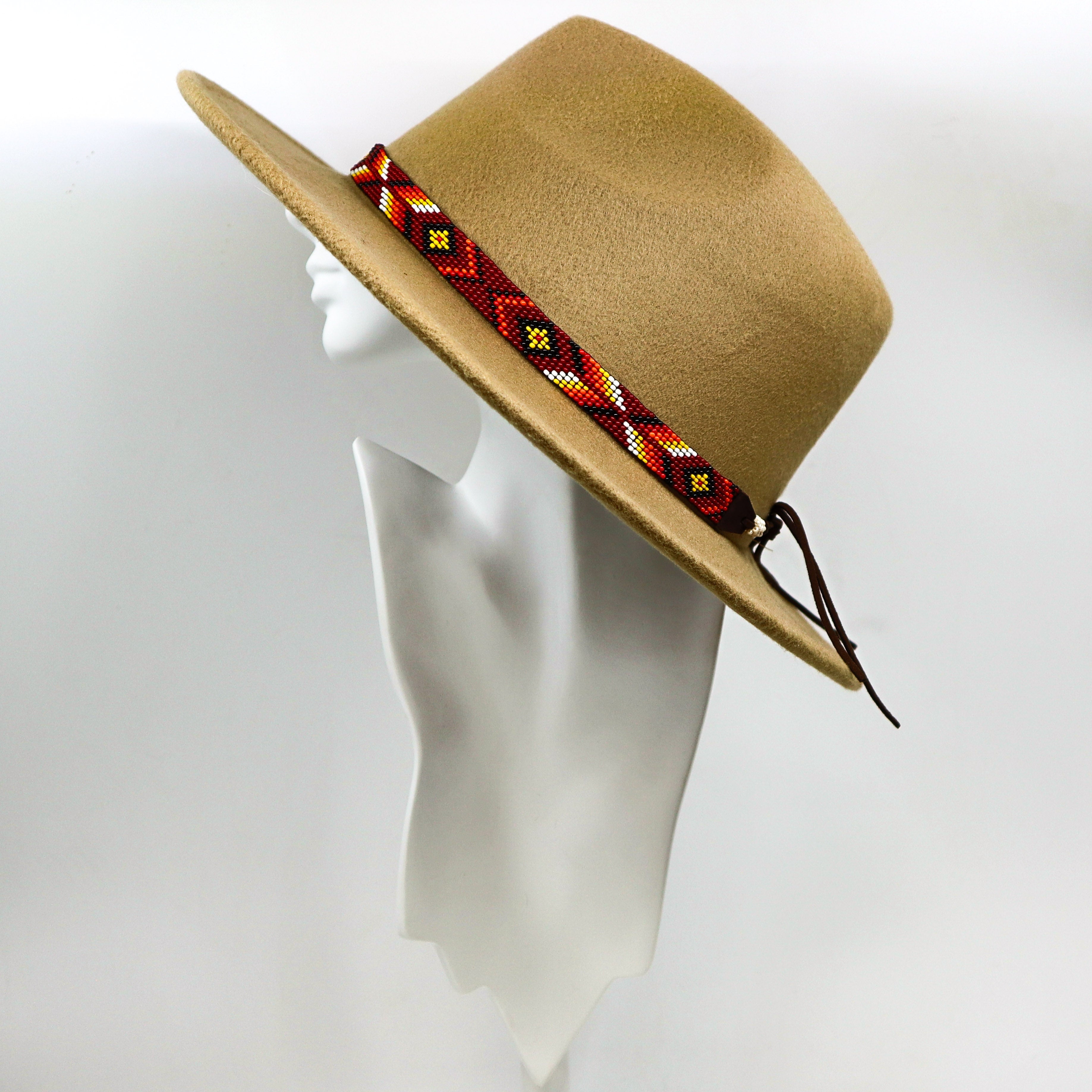 Hand-beaded hat band with intricate red and yellow geometric beadwork on tan felt cowboy hat