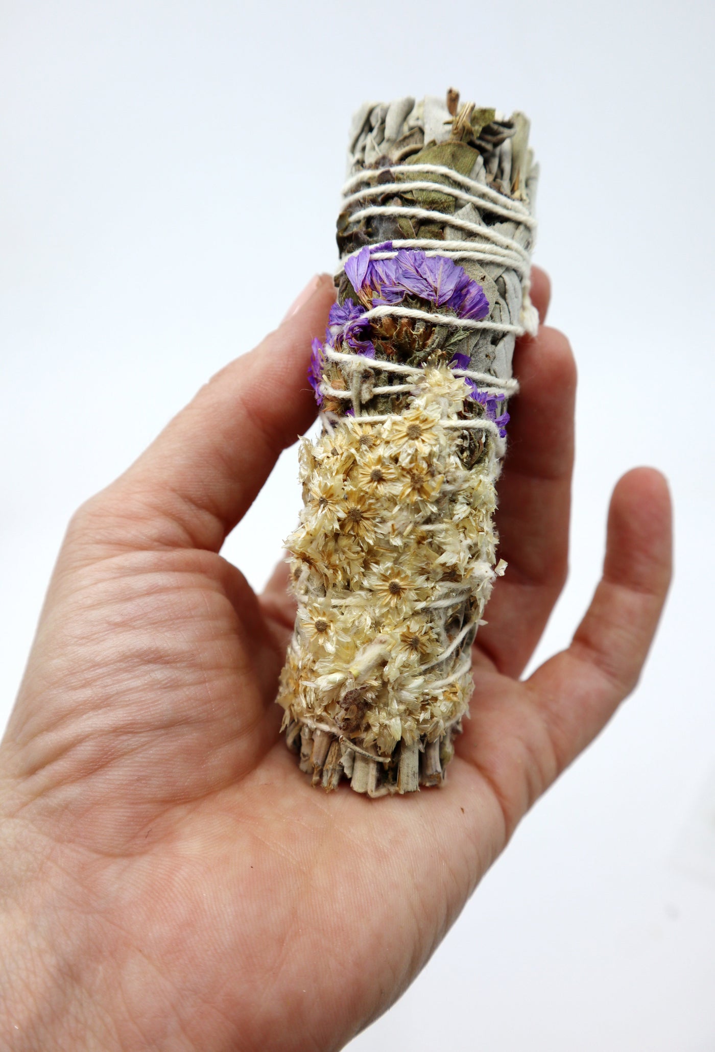 4" Sage Smudge Stick in hand - ethically sourced, all-natural California sage bundle for smudging rituals.