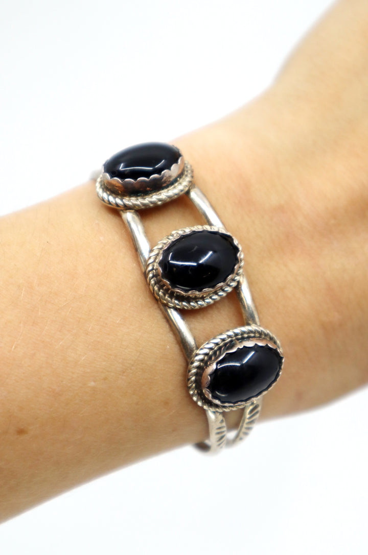 Handmade Navajo sterling silver cuff bracelet with three oval onyx stones